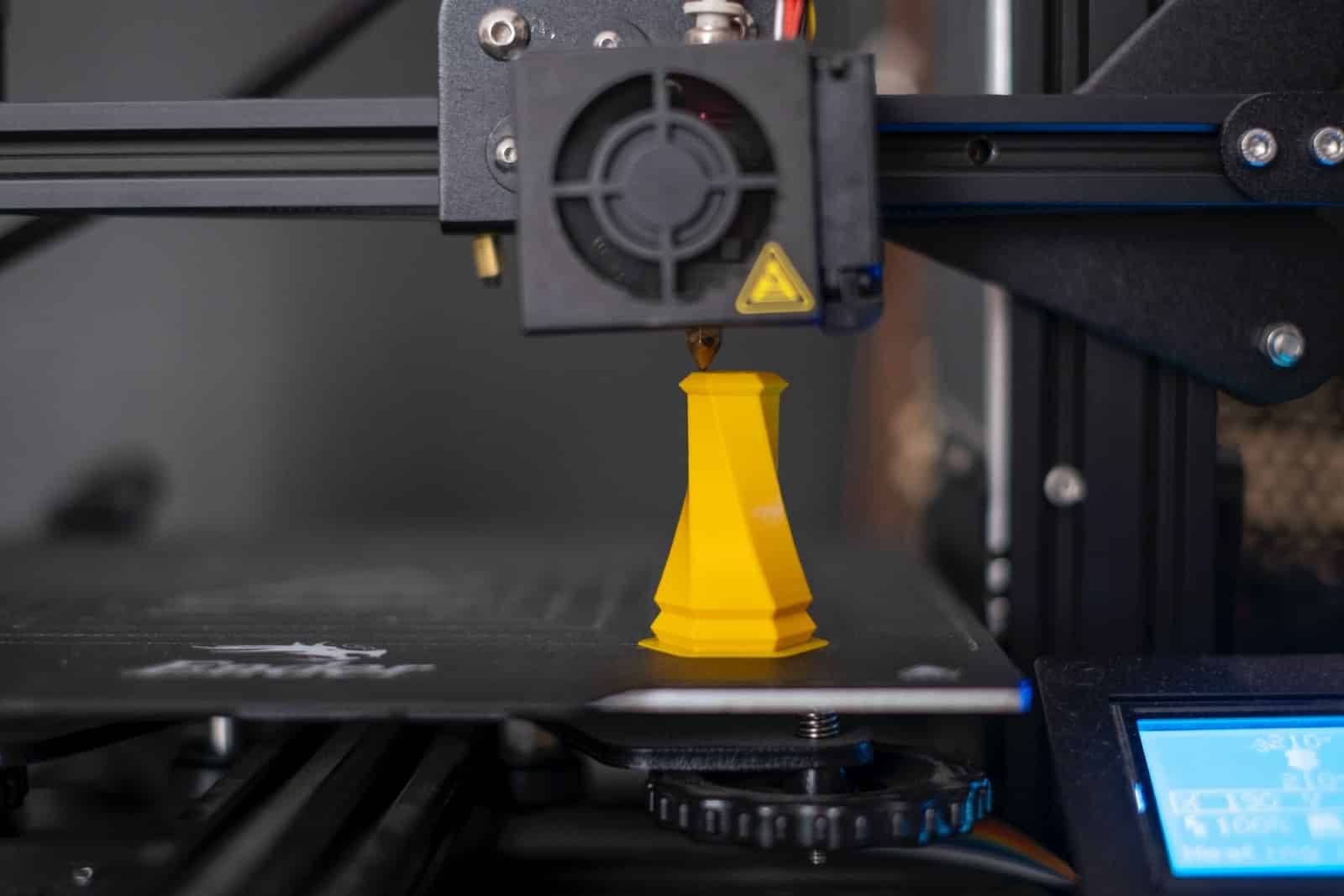 a 3d printer with a yellow cone on top of it
